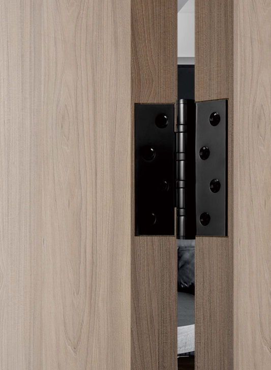 Wooden door with a black metal hinge