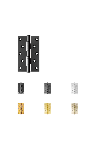 Set of black and gold door hinges on a white background