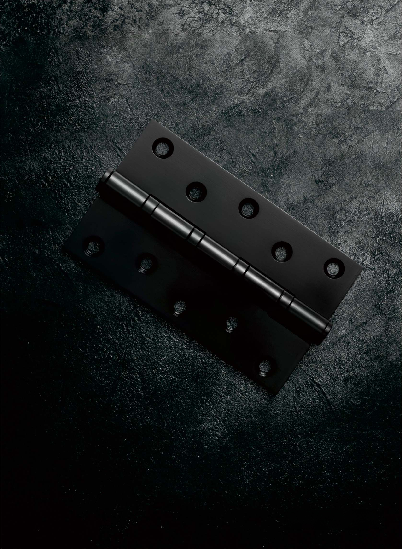 Black metal hinge on a dark textured surface