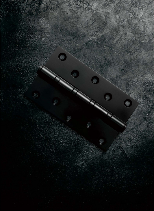 Black metal hinge on a dark textured surface