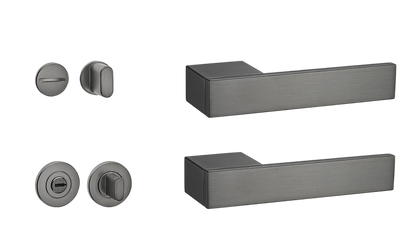 Set of black door handles and lock components on a white background