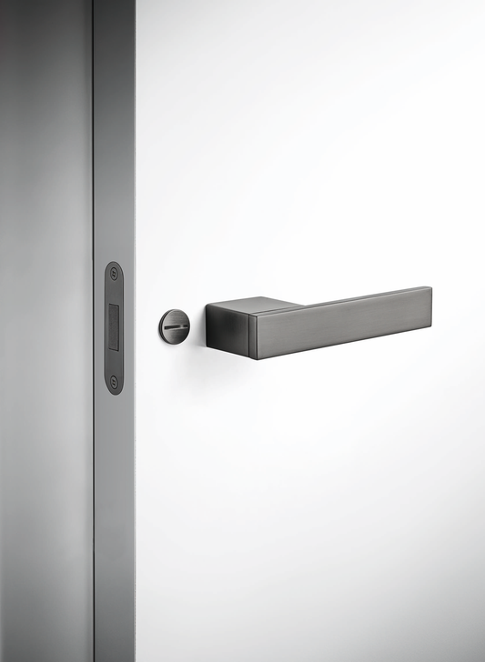 Close-up of a door handle and lock on a glass door